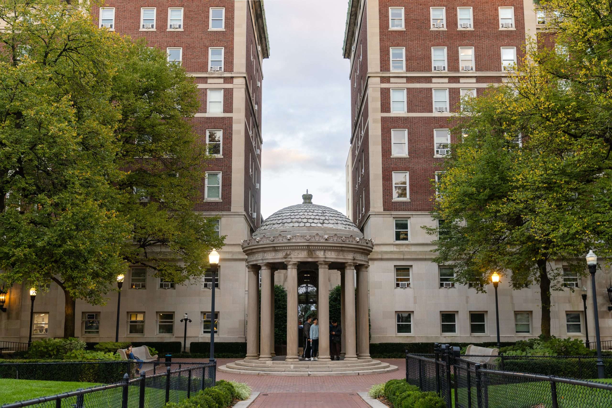 Two brick buildings are joined by a circular rotunda at Columbia University.