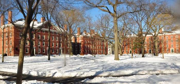 Photo graph of brick buildings on a snowy college campus