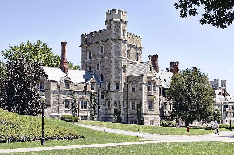 A stone college campus building is featured in this wide shot.